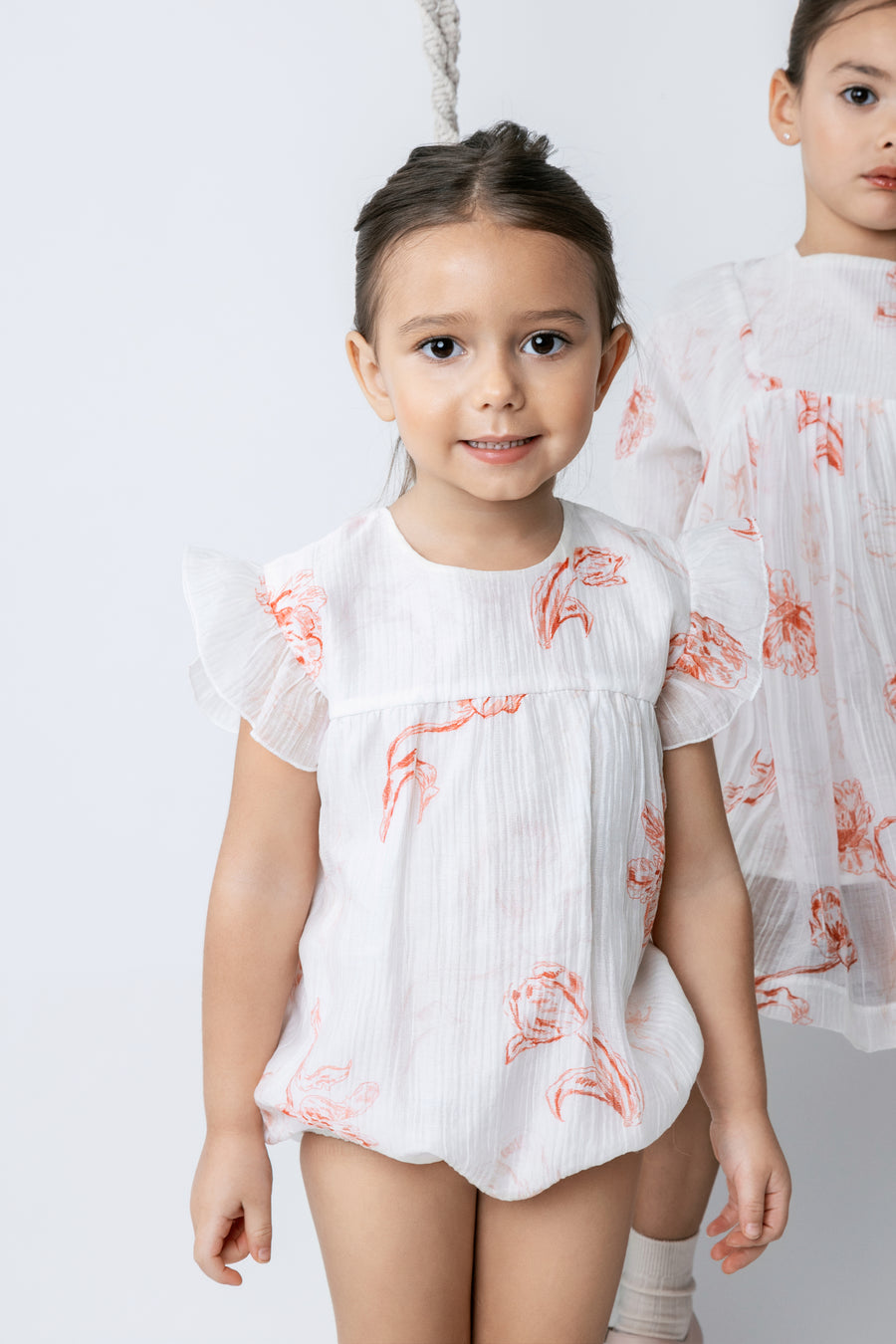 Printed floral peach romper by Noma