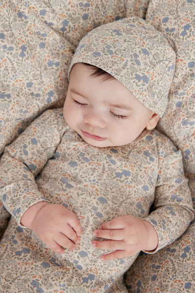 Floral blue footie + hat by Kipp Baby